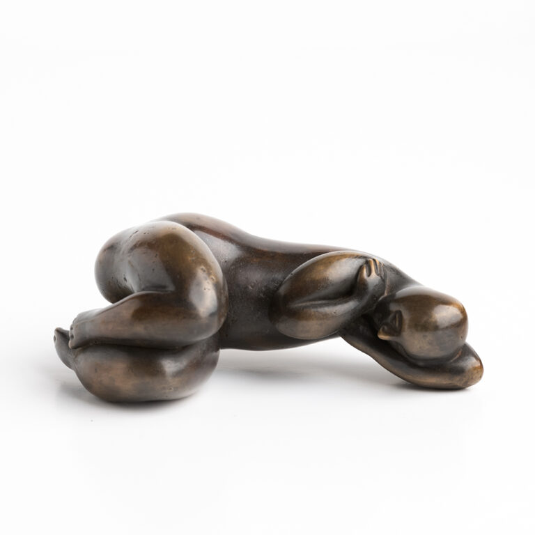 Mini female figure lying on side